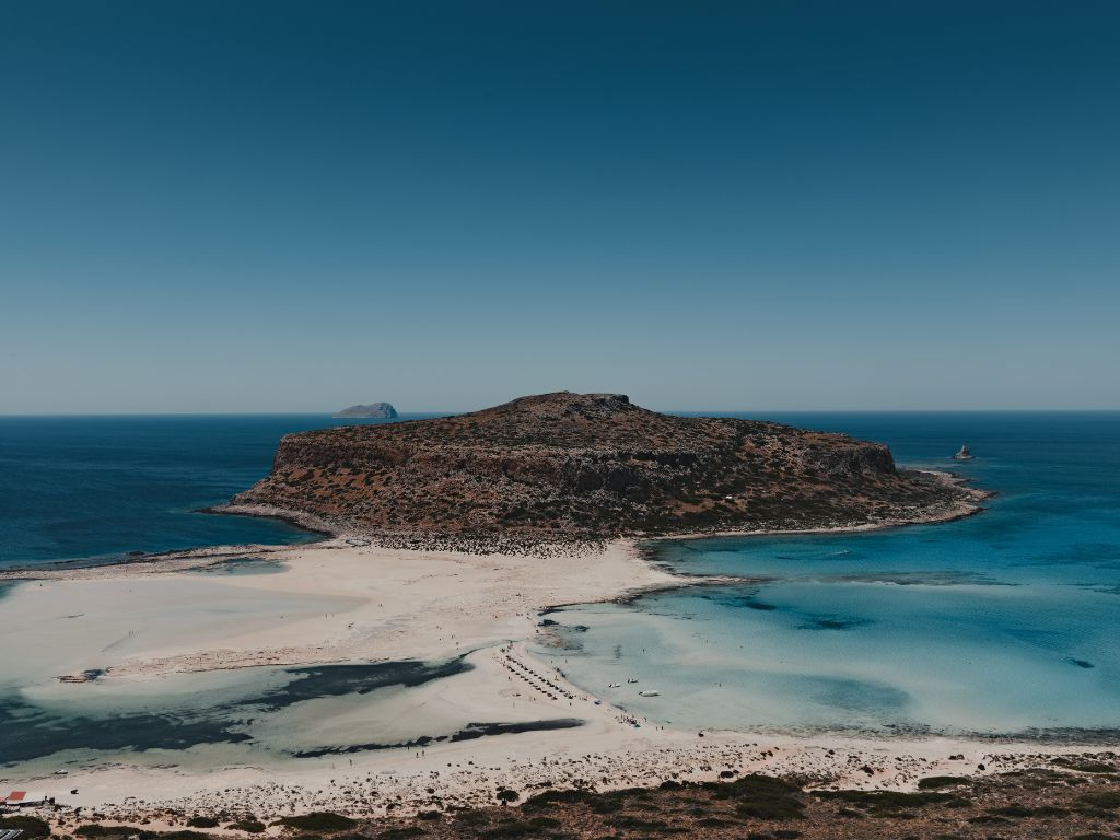 Aerial view of a secluded turquoise beach in Chania, Crete